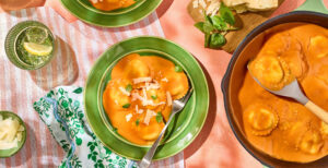 An image of prepared 3-Ingredient Creamy Tomato Basil Ravioli made with Pacific Foods™ Organic Vegan Creamy Tomato Basil Soup, cheese ravioli and Parmesan cheese.