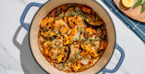 An image of prepared One-Pan Roast Chicken with Seasonal Vegetable made with chicken, squash, sweet potato, onion, cannellini beans and Pacific Foods® Organic Low Sodium Free Range Chicken Broth.