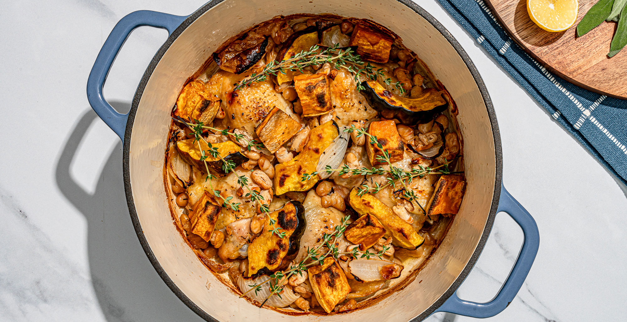 An image of prepared 8-Ingredient One Pan Roast Chicken with Seasonal Vegetable made with chicken, squash, sweet potato, onion, cannellini beans and Pacific Foods® Organic Low Sodium Free Range Chicken Broth.