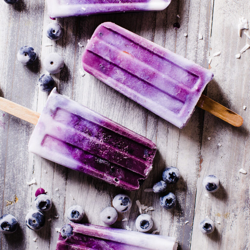 An image of prepared Banana Blueberry Coconut Cream Popsicles made with Pacific Foods® Organic Coconut Unsweetened Original Beverage, blueberries and banana.