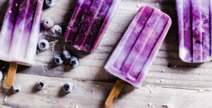 An image of prepared Banana Blueberry Coconut Cream Popsicles made with Pacific Foods® Organic Coconut Unsweetened Original Beverage, blueberries and banana.