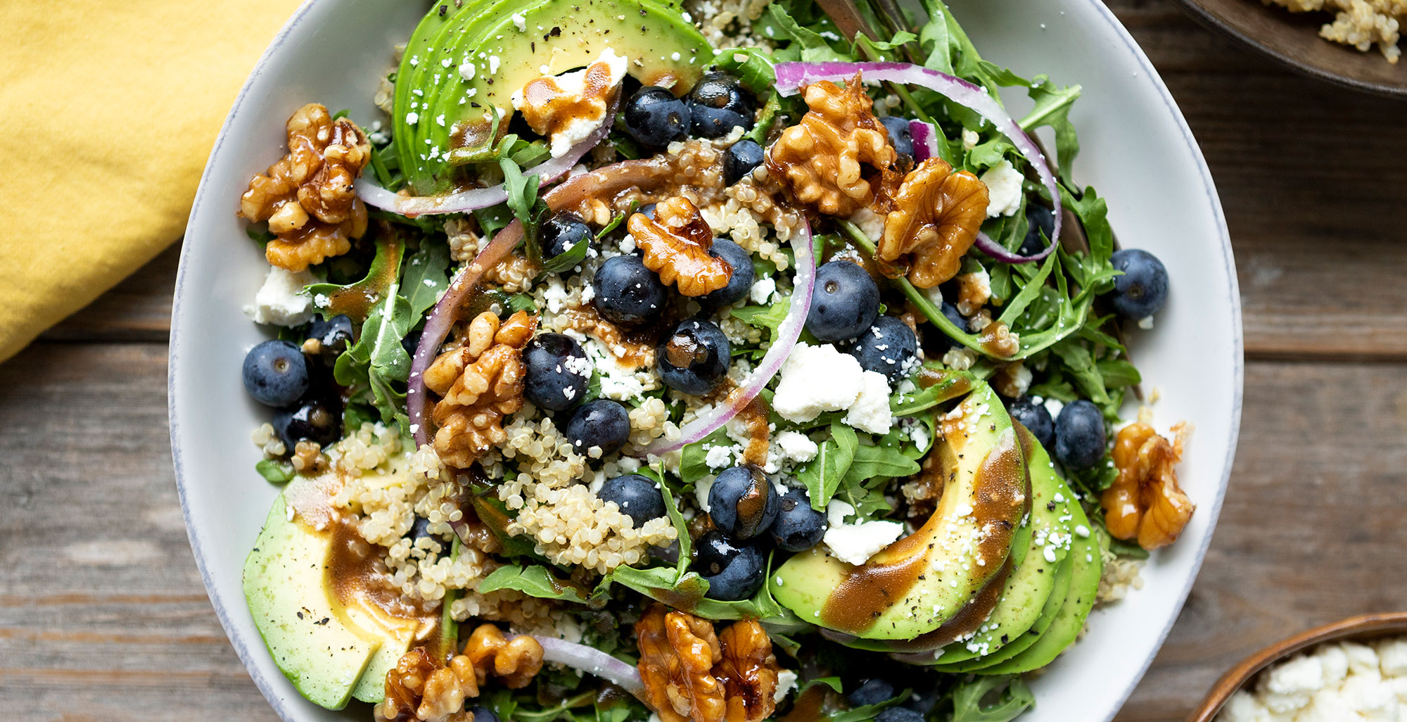 An image of prepared Blueberry, Quinoa, and Feta Salad with Candied Walnuts made with Pacific Foods® Organic Vegetable Broth, quinoa, arugula, walnuts, blueberries, feta and red onion.