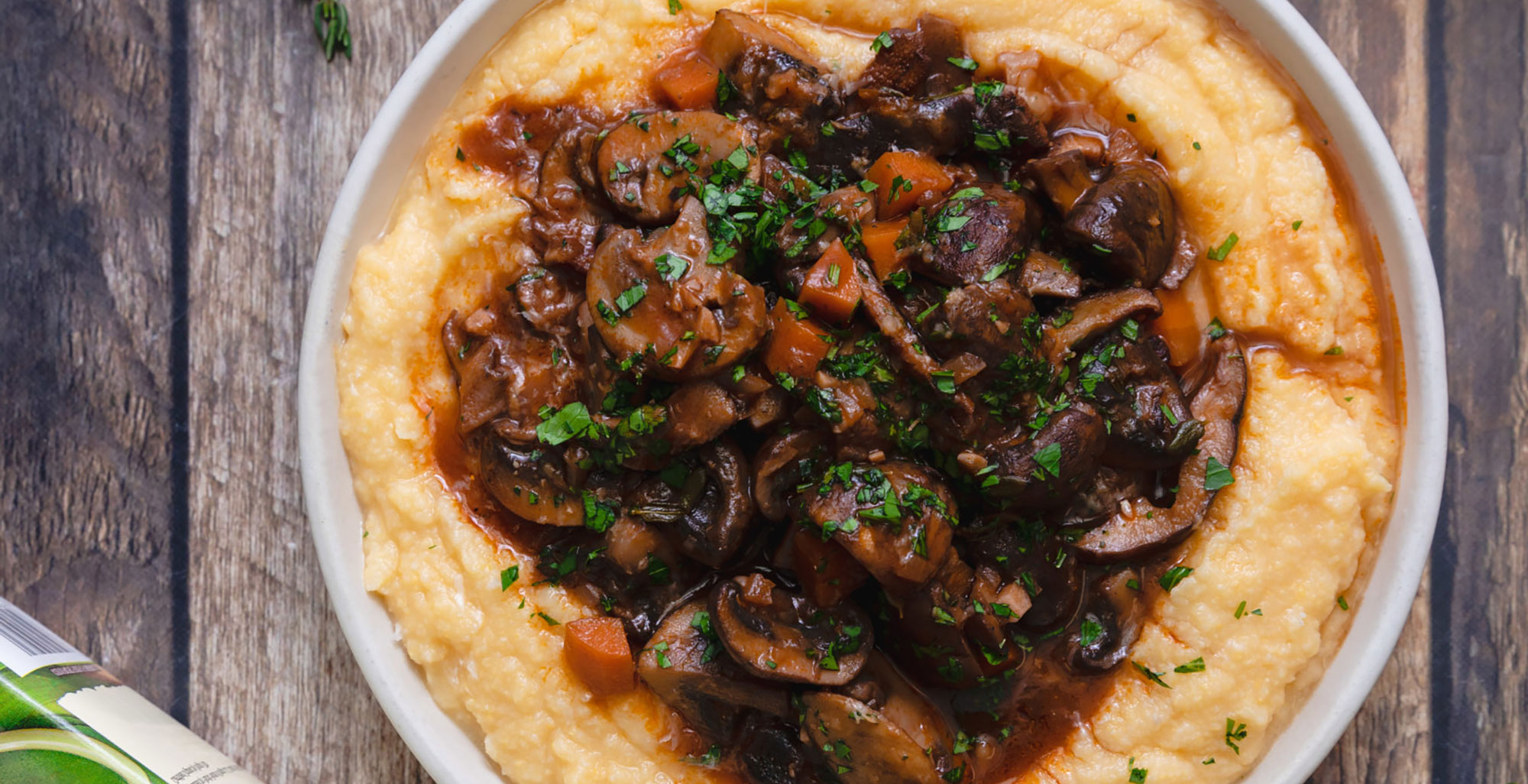 An image of prepared Braised Mushrooms with Polenta made with Pacific Foods® Organic Low Sodium Vegetable Broth, red wine, thyme, polenta and assorted mushrooms.