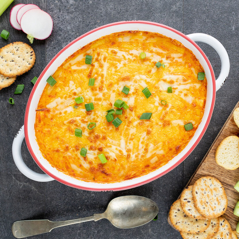 An image of prepared Buffalo Chicken Party Dip made with chicken, Buffalo hot wing sauce, Pacific Foods® Organic Cream of Chicken Condensed Soup, cream cheese, sour cream, Cheddar and mozzarella.