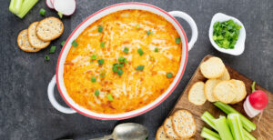 An image of prepared Buffalo Chicken Party Dip made with chicken, Buffalo hot wing sauce, Pacific Foods® Organic Cream of Chicken Condensed Soup, cream cheese, sour cream, Cheddar and mozzarella.