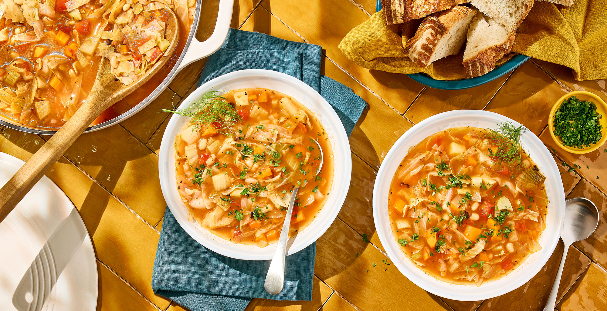 An image of prepared Cabbage and White Bean Soup made with carrot, fennel, garlic, green cabbage, tomatoes, Pacific Foods® Organic Unsalted Chicken Bone Broth, and white beans.