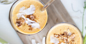 An image of prepared Carrot Cake Smoothie made with Pacific Foods® Organic Unsweetened Almond Beverage, carrot, banana, pineapple, coconut, almond butter, hemp seeds and walnuts.