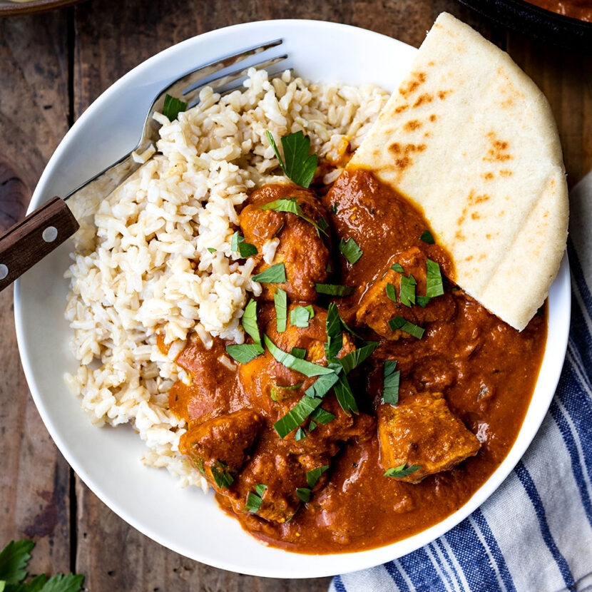 An image of prepared Chicken Tikka Masala made with Pacific Foods® Organic Free Range Low Sodium Chicken Broth, Pacific Foods® Organic Coconut Unsweetened Plant-Based Beverage, cilantro, tomato, ginger, garam masala and chicken.