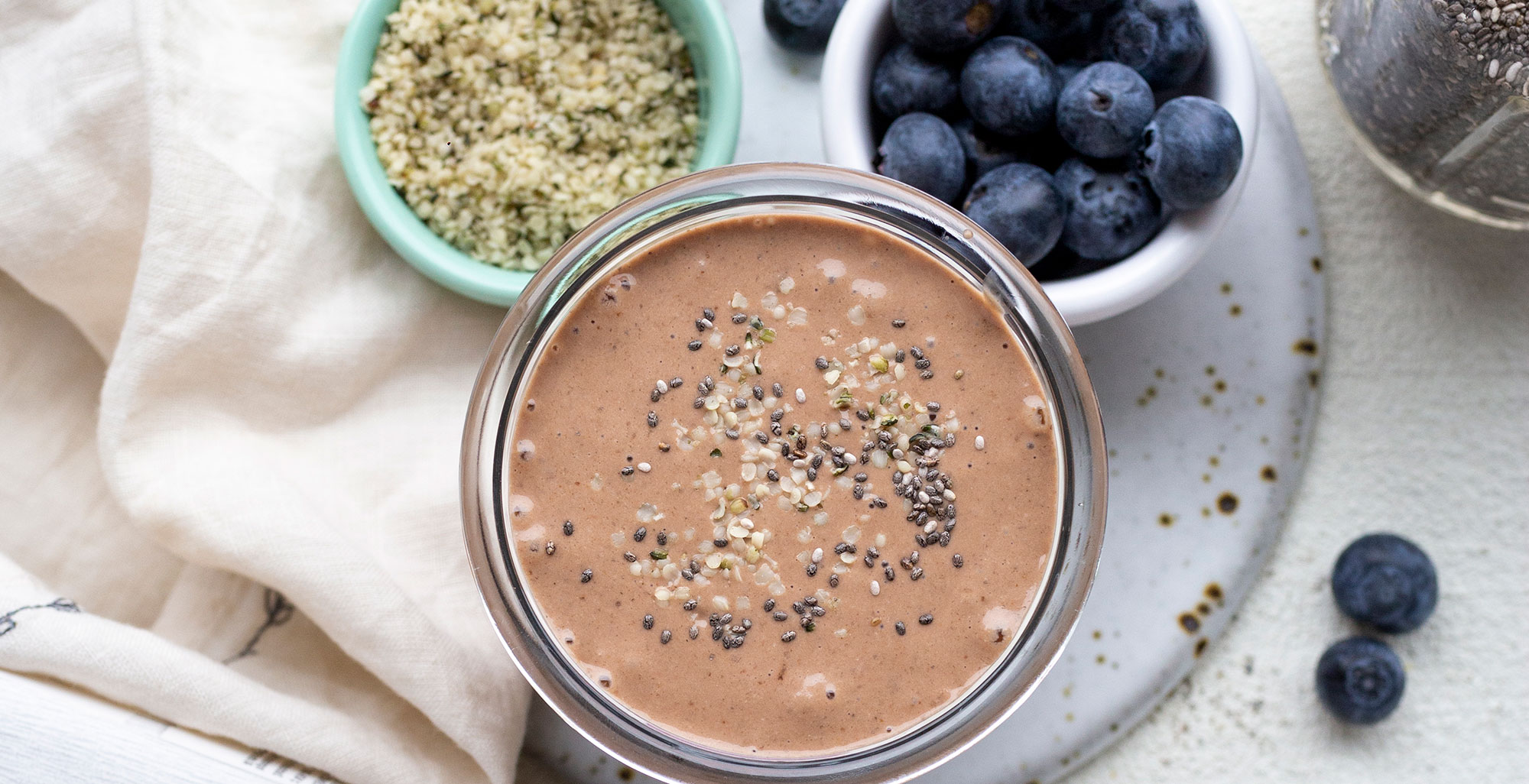 An image of prepared Chocolate Protein Shake made with banana, oats, cocoa powder, dates and Pacific Foods® Hemp Unsweetened Original Beverage.