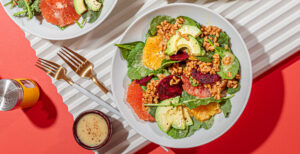 An image of prepared Citrus, Beet & Farro Salad with Lemon Tarragon Vinaigrette made with farro, Pacific Foods® Organic Vegetable Broth, beets, mixed greens, citrus and avocado.