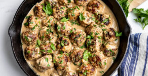 An image of prepared Classic Swedish Meatballs made with ground beef, ground pork, Pacific Foods® Organic Beef Broth, half and half and parsley.