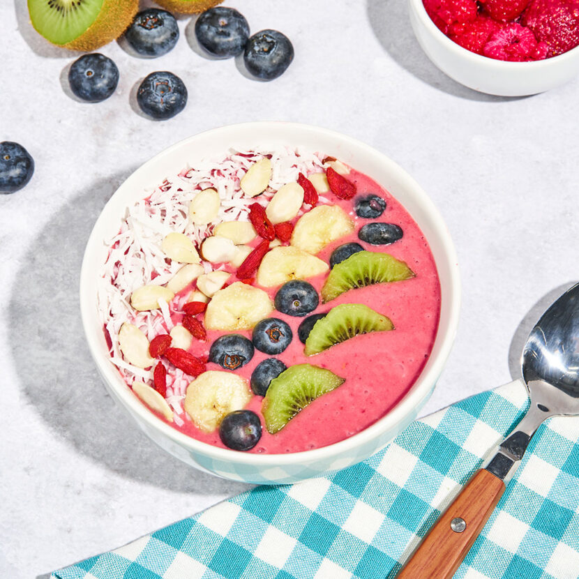 An image of prepared Coconut Açaí Bowl made with Pacific Foods® Organic Coconut Original Beverage, raspberries, strawberries, banana, kiwi, blueberries, almonds, coconut and goji berries.