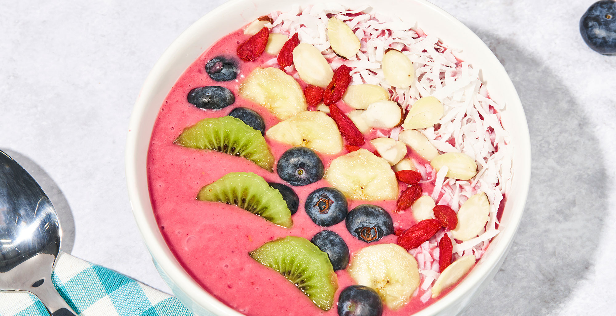 An image of prepared Coconut Açaí Bowl made with Pacific Foods® Organic Coconut Original Beverage, raspberries, strawberries, banana, kiwi, blueberries, almonds, coconut and goji berries.