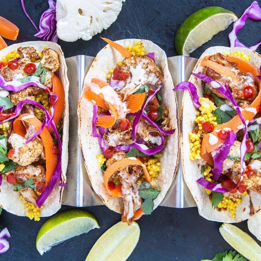 An image of prepared Coconut Cauliflower Tacos made with cauliflower, Pacific Foods® Organic Coconut Unsweetened Original Beverage, quinoa, corn tortillas, cilantro, red cabbage and carrots.