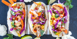 An image of prepared Coconut Cauliflower Tacos made with cauliflower, Pacific Foods® Organic Coconut Unsweetened Original Beverage, quinoa, corn tortillas, cilantro, red cabbage and carrots.