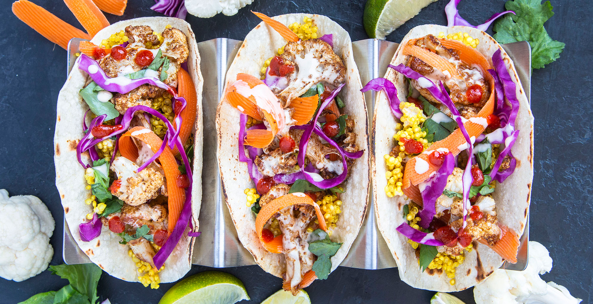An image of prepared Coconut Cauliflower Tacos made with cauliflower, Pacific Foods® Organic Coconut Unsweetened Original Beverage, quinoa, corn tortillas, cilantro, red cabbage and carrots.