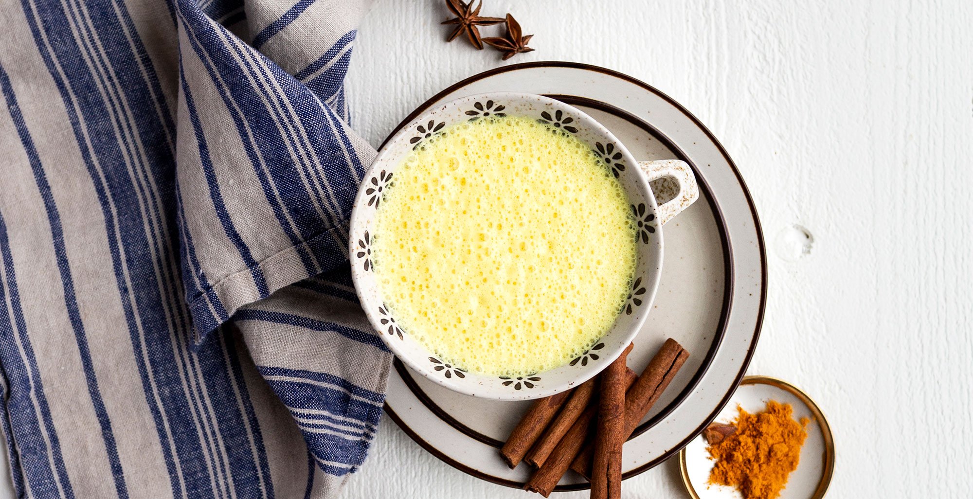 An image of prepared Coconut Turmeric Latte made with Pacific Foods® Organic Coconut Unsweetened Plant-Based Beverage, turmeric, cinnamon and honey.