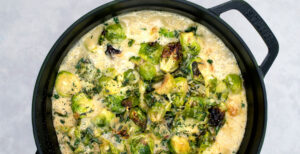 An image of prepared Creamy Brussels Sprouts Bake made with Brussels sprouts, Pacific Foods® Organic Cream of Mushroom Condensed Soup, creamy and Gruyére cheese.