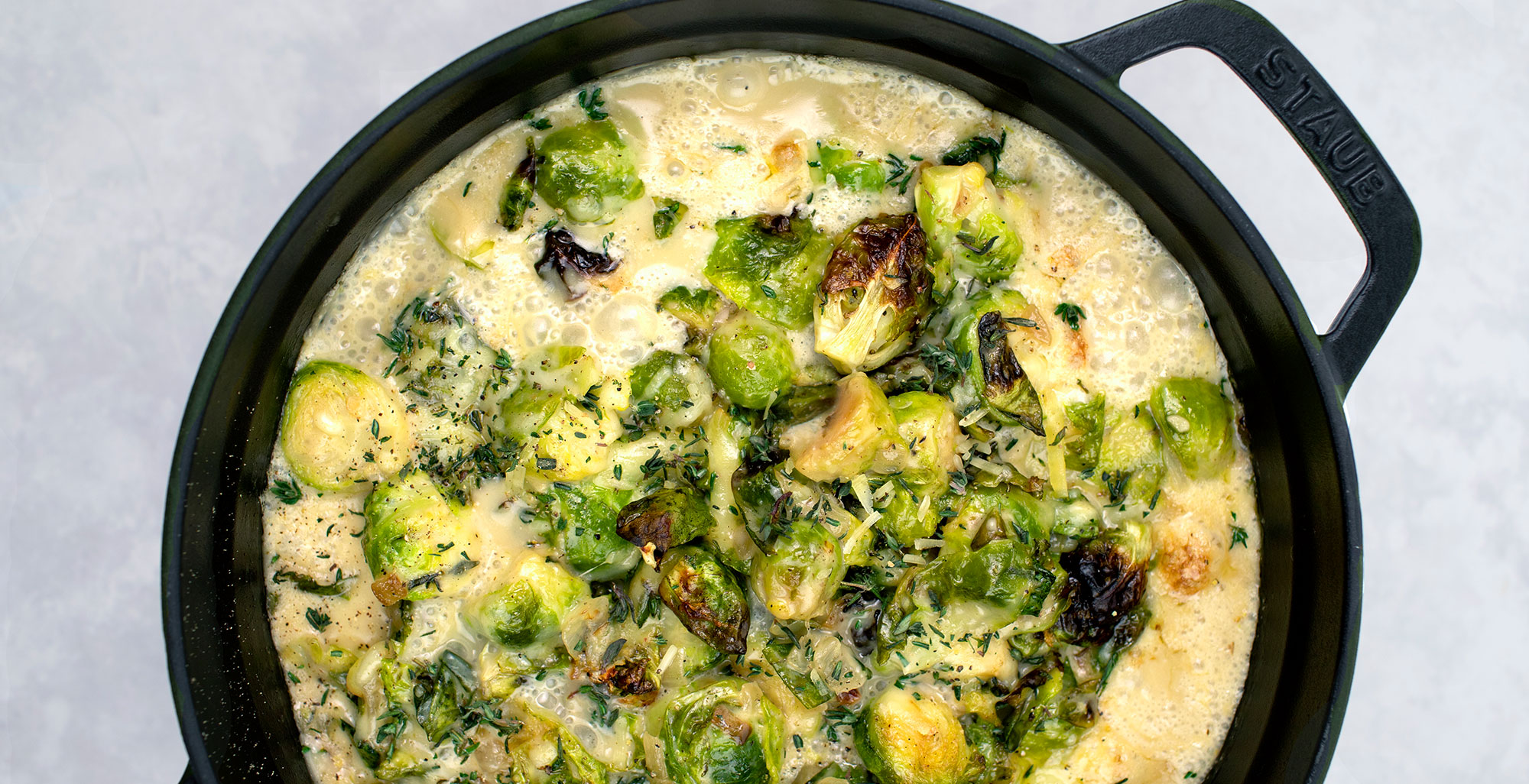 An image of prepared Creamy Brussels Sprouts Bake made with Brussels sprouts, Pacific Foods® Organic Cream of Mushroom Condensed Soup, creamy and Gruyére cheese.