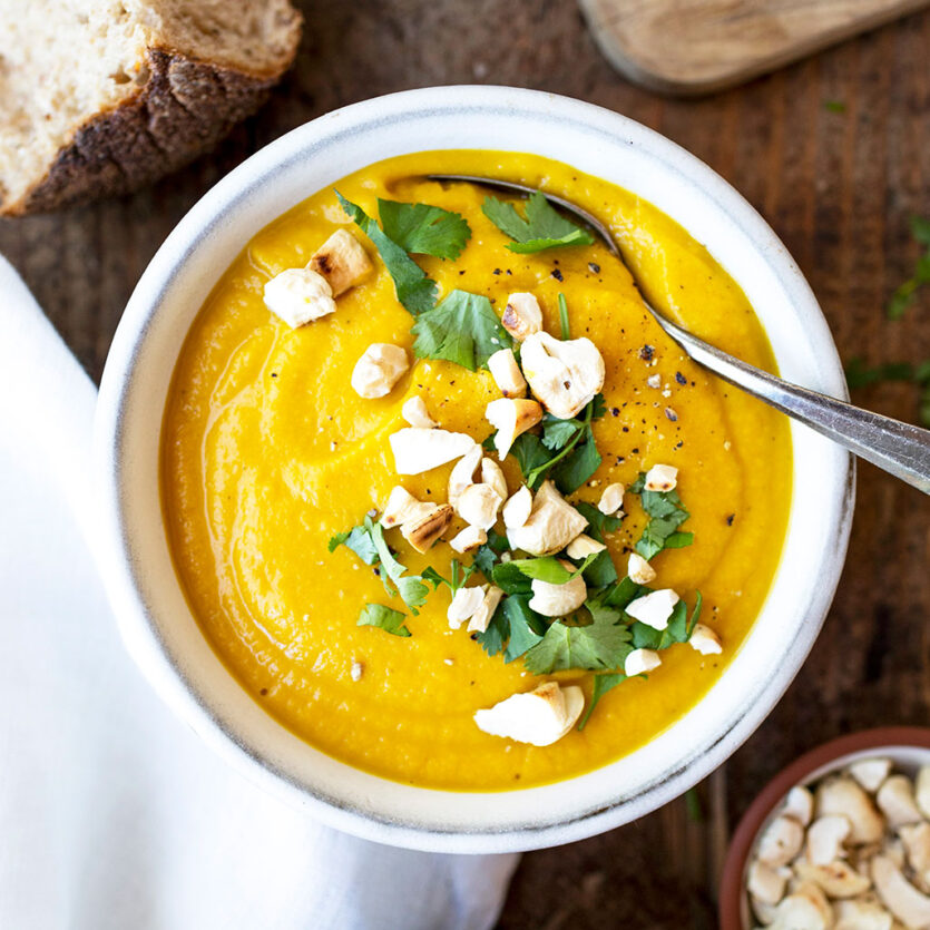 An image of prepared Creamy Carrot and White Bean Soup made with ginger, carrot, Pacific Foods® Organic Vegetable Broth, cannellini beans and cashews.