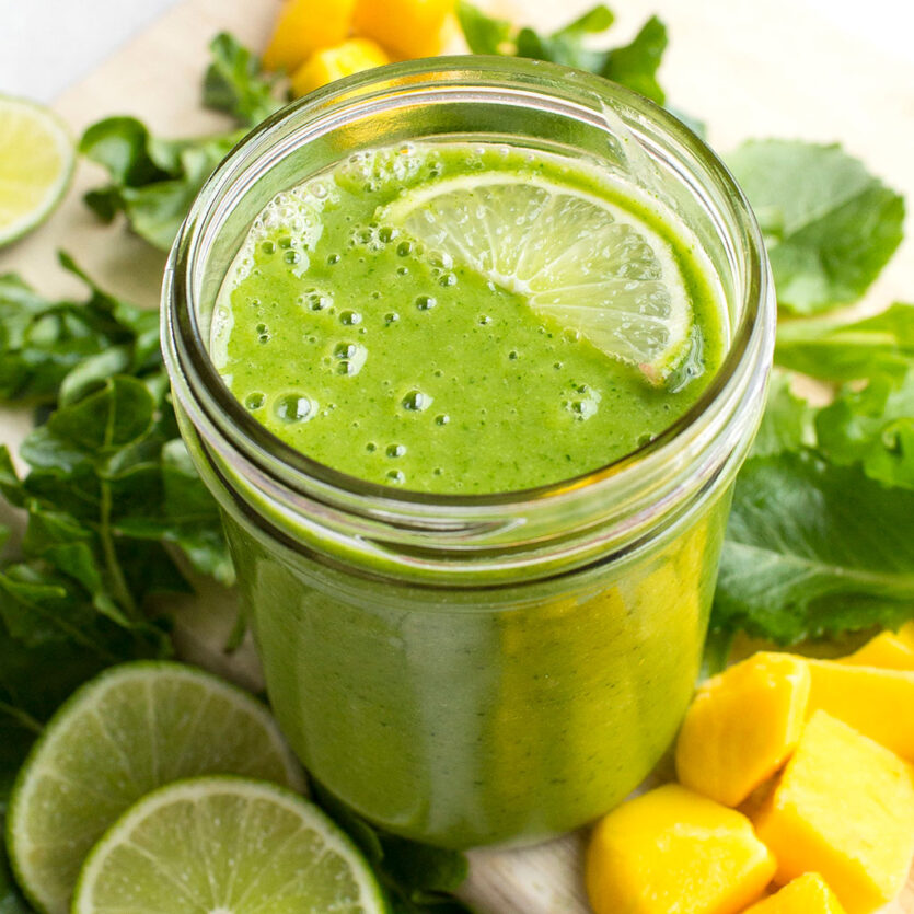 An image of prepared Dairy- Free Tropical Mango Green Smoothie made with banana, mixed salad greens, Pacific Foods® Organic Oat Original Beverage, pineapple, mango and lime juice.