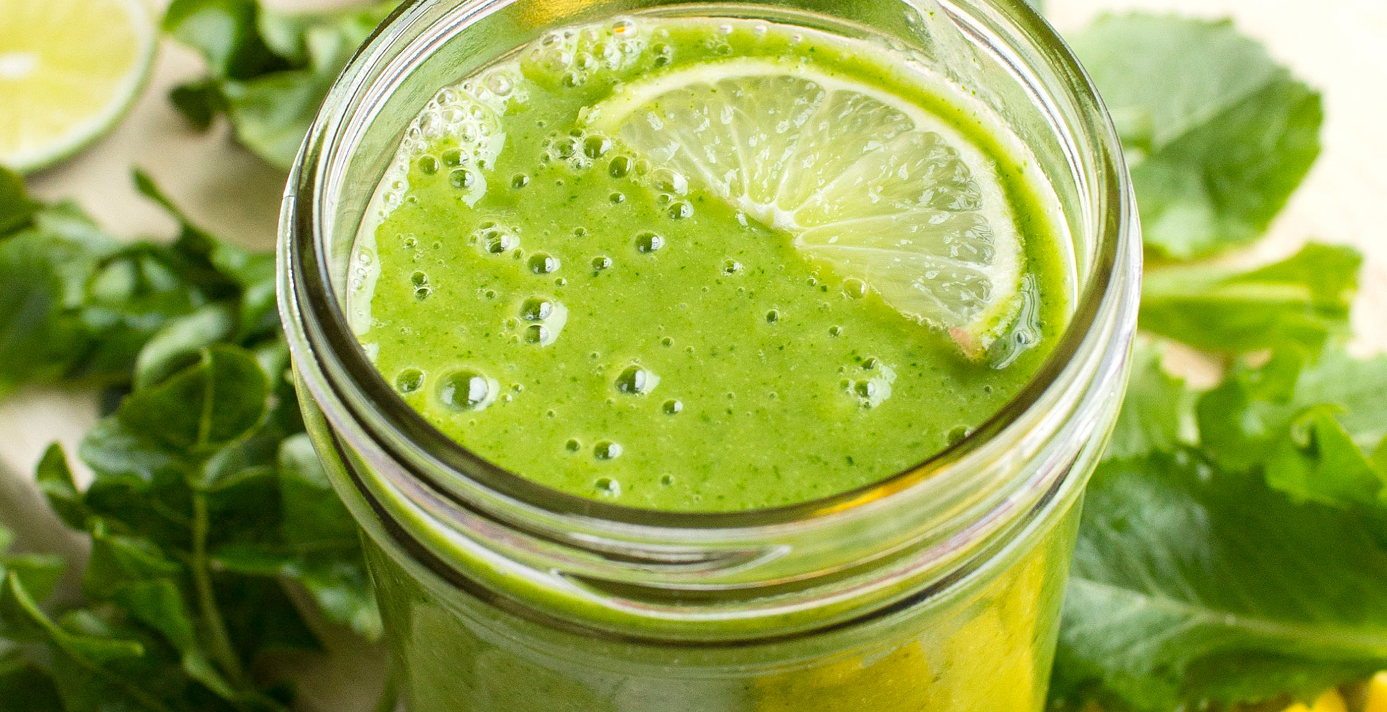 An image of prepared Dairy-Free Tropical Mango Green Smoothie made with banana, mixed salad greens, Pacific Foods® Organic Oat Original Beverage, pineapple, mango and lime juice.