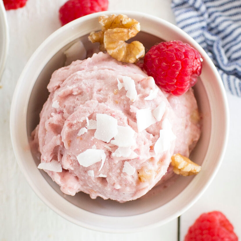 An image of prepared Dairy-Free Coconut Raspberry "Nice" Cream made with banana, raspberries, Pacific Foods® Organic Coconut Unsweetened Original Beverage, walnuts, raspberries and coconut flakes.