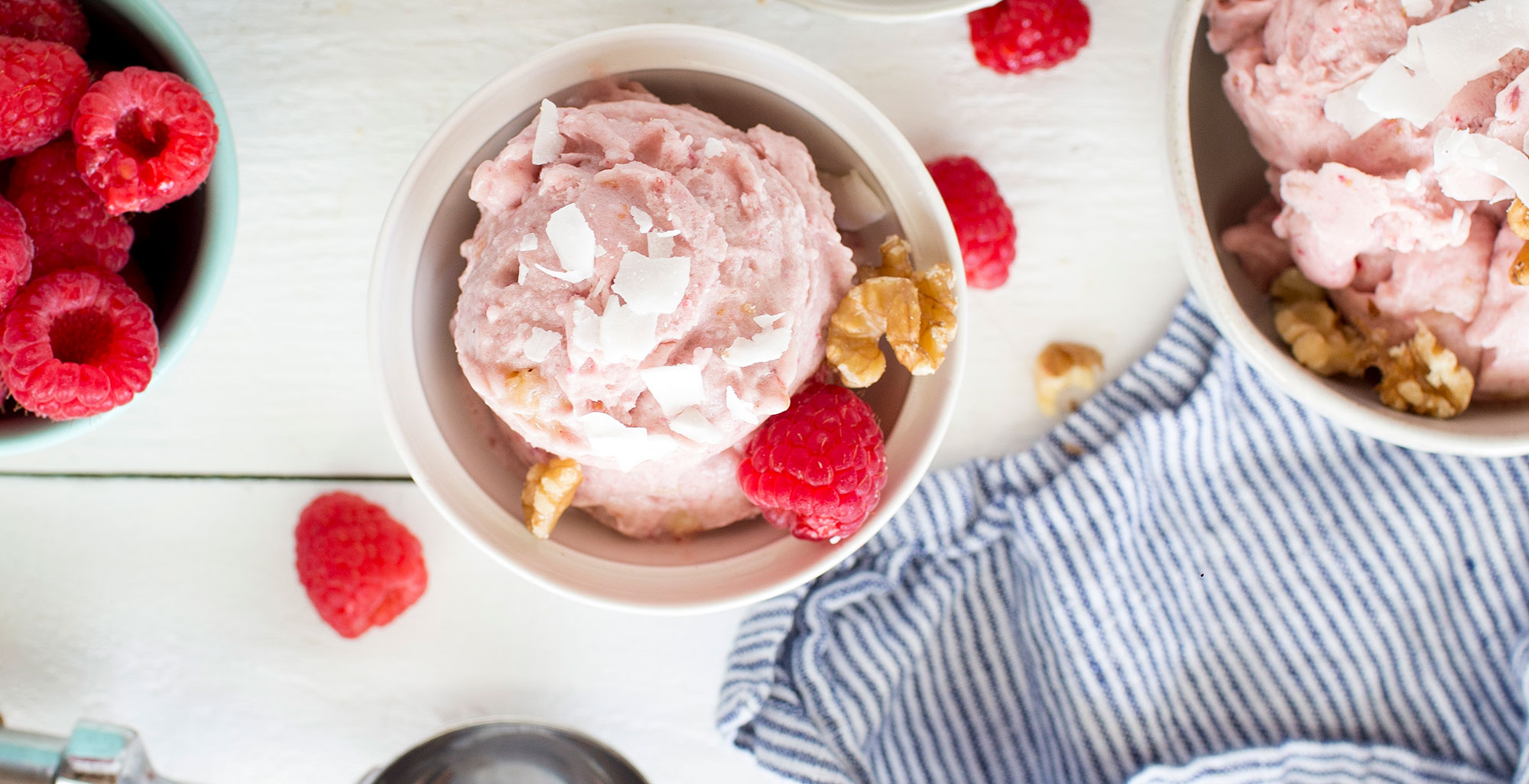 An image of prepared Dairy-Free Coconut Raspberry "Nice" Cream made with banana, raspberries, Pacific Foods® Organic Coconut Unsweetened Original Beverage, walnuts, raspberries and coconut flakes.