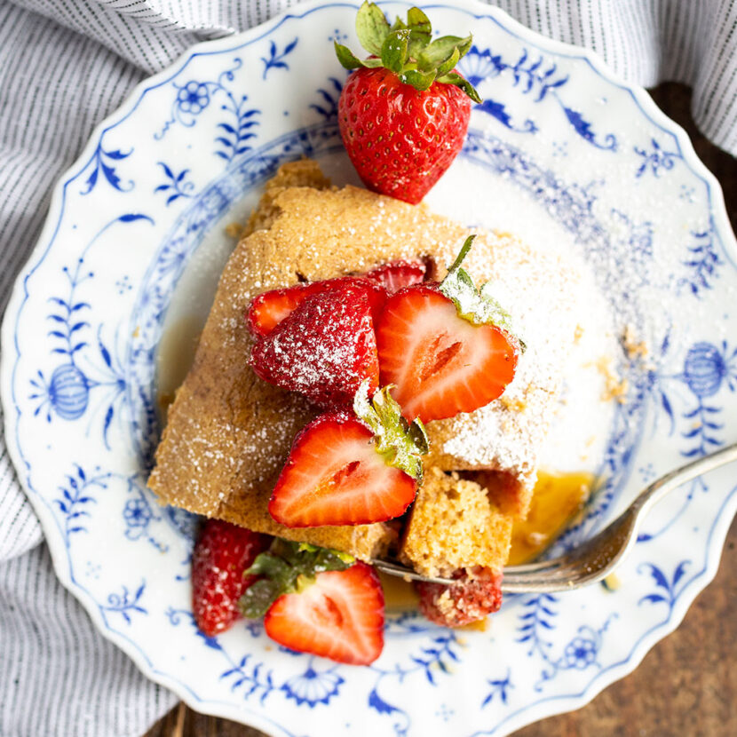 An image of prepared Dairy-Free Strawberry Sheet-Pan Pancakes made with Pacific Foods® Hemp Original Beverage, flour, eggs, maple syrup, strawberries and powdered sugar.