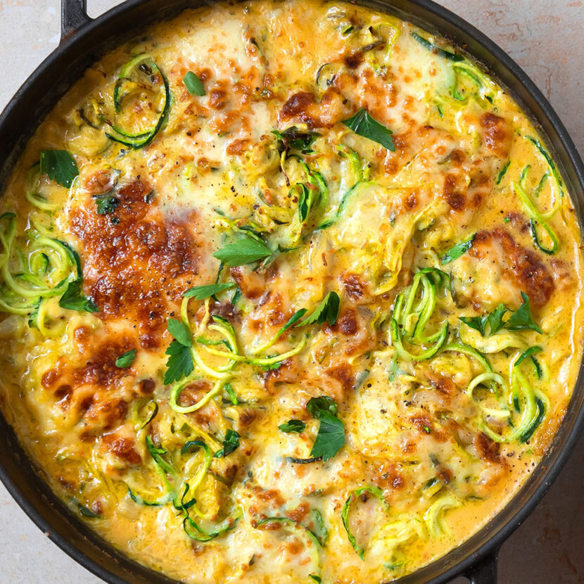 An image of prepared French Onion Zoodle Bake made with zucchini, onion, dry sherry, Pacific Foods® Organic Creamy Butternut Squash Soup, cream cheese and fontina cheese.
