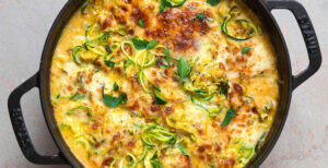 An image of prepared French Onion Zoodle Bake made with zucchini, onion, dry sherry, Pacific Foods® Organic Creamy Butternut Squash Soup, cream cheese and fontina cheese.