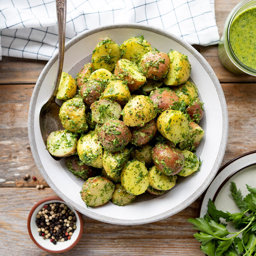 An image of prepared Garlic Potato Salad with Herby-Green Sauce made with Pacific Foods® Organic Chicken Bone Broth with Sea Salt, baby red potatoes, garlic, basil, dill, parsley and tahini paste.