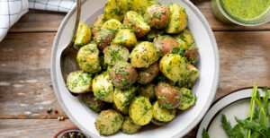 An image of prepared Garlic Potato Salad with Herby-Green Sauce made with Pacific Foods® Organic Chicken Bone Broth with Sea Salt, baby red potatoes, garlic, basil, dill, parsley and tahini paste.