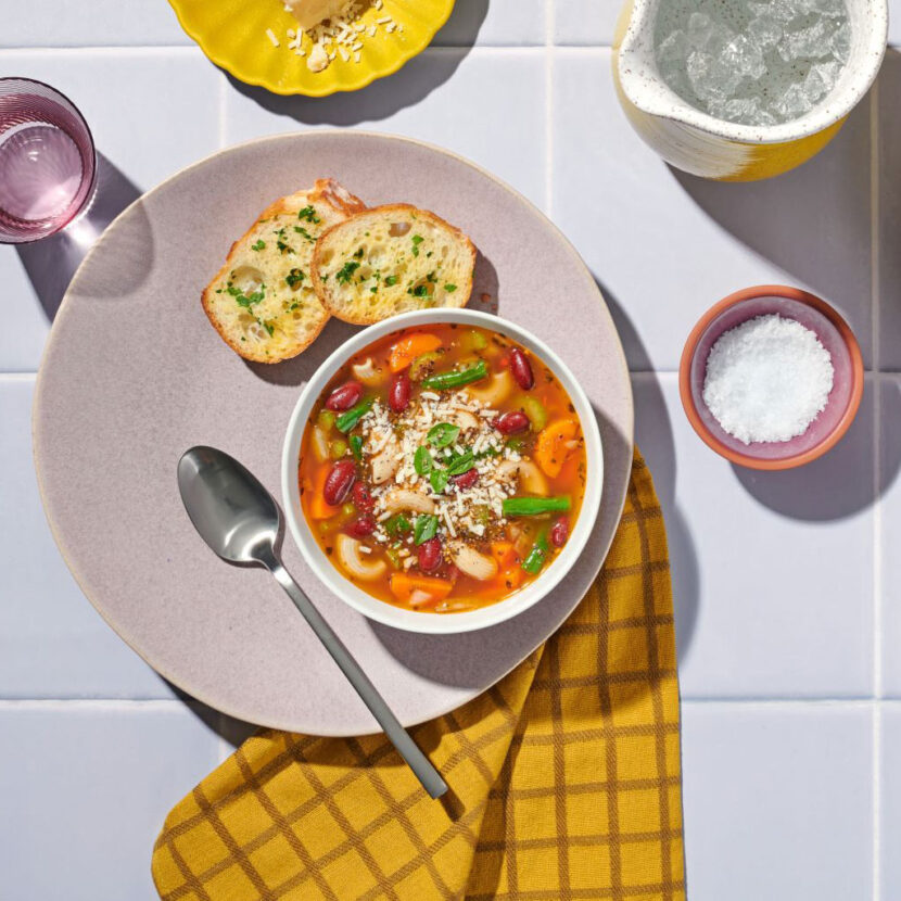An image of prepared Gluten-Free Minestrone Soup made with gluten-free elbow pasta, carrots, celery, onions, Pacific Foods® Organic Vegetable Broth, kidney beans and green beans.