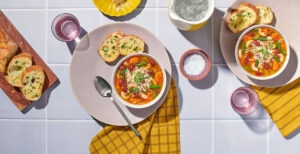 An image of prepared Gluten-Free Minestrone Soup made with gluten-free elbow pasta, carrots, celery, onions, Pacific Foods® Organic Vegetable Broth, kidney beans and green beans.