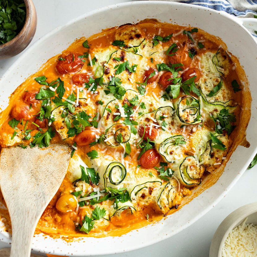 An image of prepared Gluten-Free Zucchini Lasagna Rollups made with zucchini, Pacific Foods® Organic Creamy Tomato Basil Soup, ricotta, mozzarella, Parmesan, cherry tomatoes and parsley.