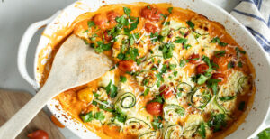 An image of prepared Gluten-Free Zucchini Lasagna Rollups made with zucchini, Pacific Foods® Organic Creamy Tomato Basil Soup, ricotta, mozzarella, Parmesan, cherry tomatoes and parsley.