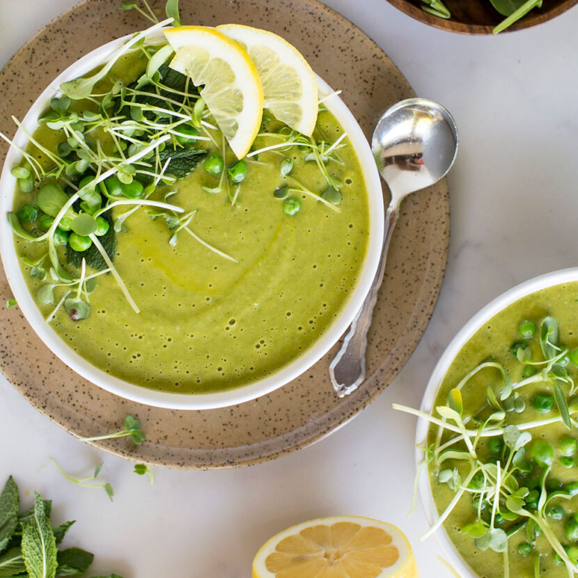 An image of prepared Green Spring Vegetable Soup made with asparagus, garlic, leeks, Pacific Foods® Organic Vegetable Broth, baby spinach, cannellini beans, peas, avocado and mint.