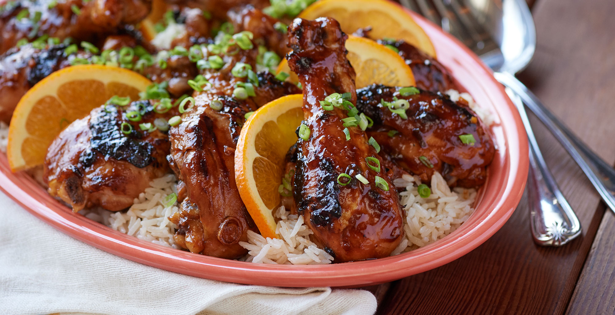 An image of prepared Hawaiian Grilled Huli Huli Chicken and Rice made with chicken drumsticks, pineapple juice, Pacific Foods® Organic Free Range Chicken Broth and ginger.