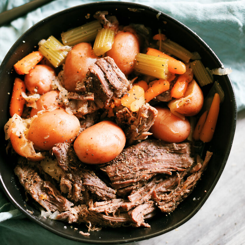 An image of prepared Instant Pot® Roast with Beef Bone Broth made with beef chuck roast, Pacific Foods® Organic Beef Bone Broth, red potatoes, onion, carrots, celery and thyme.
