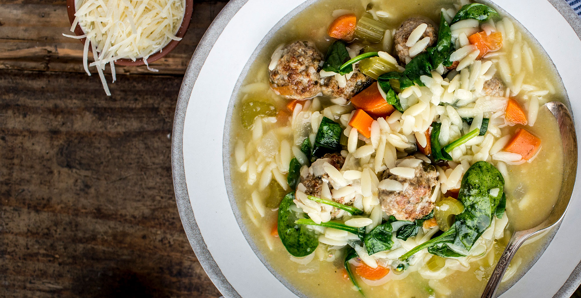 An image of prepared Italian Wedding Soup made with ground pork, ground beef, Parmesan, Pacific Foods® Organic Chicken Bone Broth with Sea Salt, spinach and orzo.
