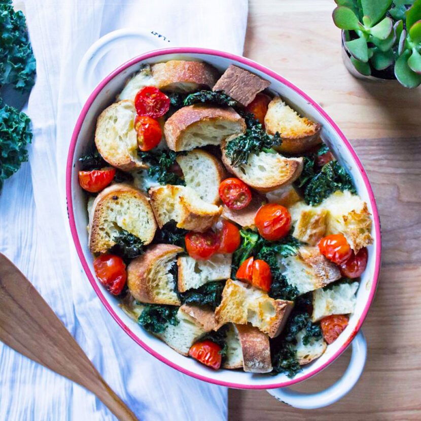 An image of prepared Kale Tomato Strata made with Pacific Foods® Organic Coconut Unsweetened Original Beverage, kale, cherry tomatoes, eggs, mozzarella cheese and French baguette.