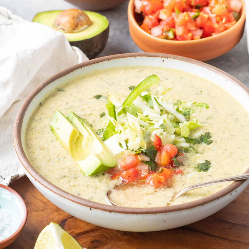 An image of prepared Keto Chile Relleno Soup made with Pacific Foods® Low Sodium Vegetable Broth, Pacific Foods® Organic Unsweetened Almond Original Beverage, poblano chiles, cilantro, avocado, cabbage and pico de gallo.