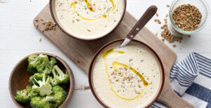 An image of prepared Keto Instant Pot® Cream of Broccoli Stalk Soup made with broccoli, Pacific Foods® Organic Unsalted Chicken Bone Broth, sunflower seeds, cream cheese and heavy cream.