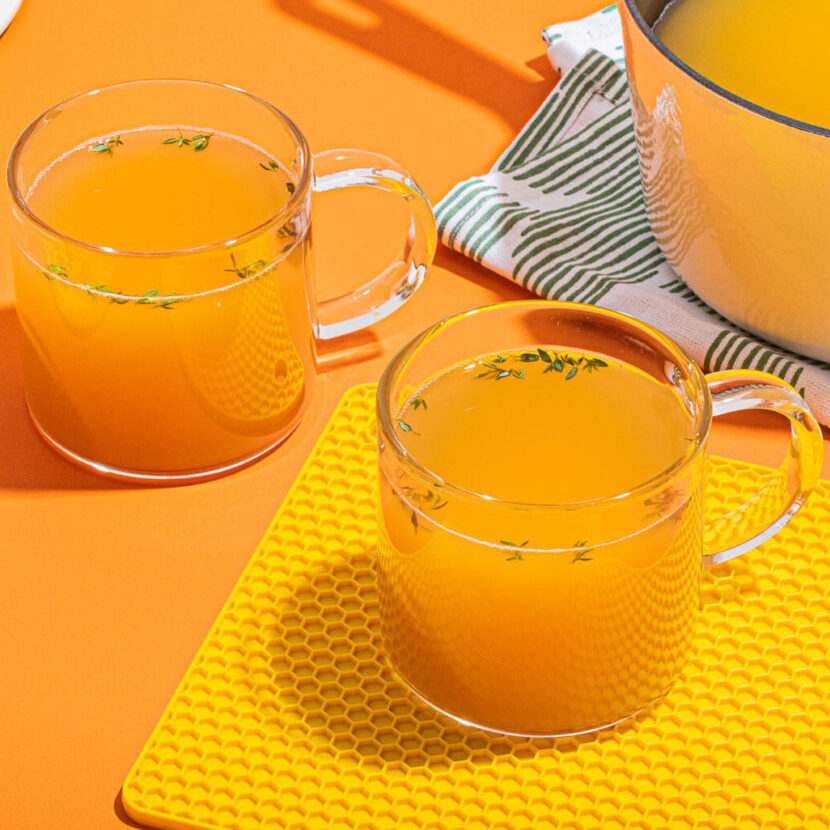An image of prepared Lemon & Ginger Chicken Bone Broth Toddy made with Pacific Foods® Organic Unsalted Chicken Bone Broth, ginger, garlic, herbs and honey.
