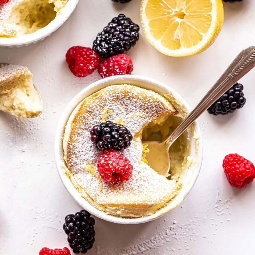 An image of prepared Lemon Pudding Cakes made with eggs, Pacific Foods® Organic Unsweetened Almond Original Beverage, lemon and mixed berries.