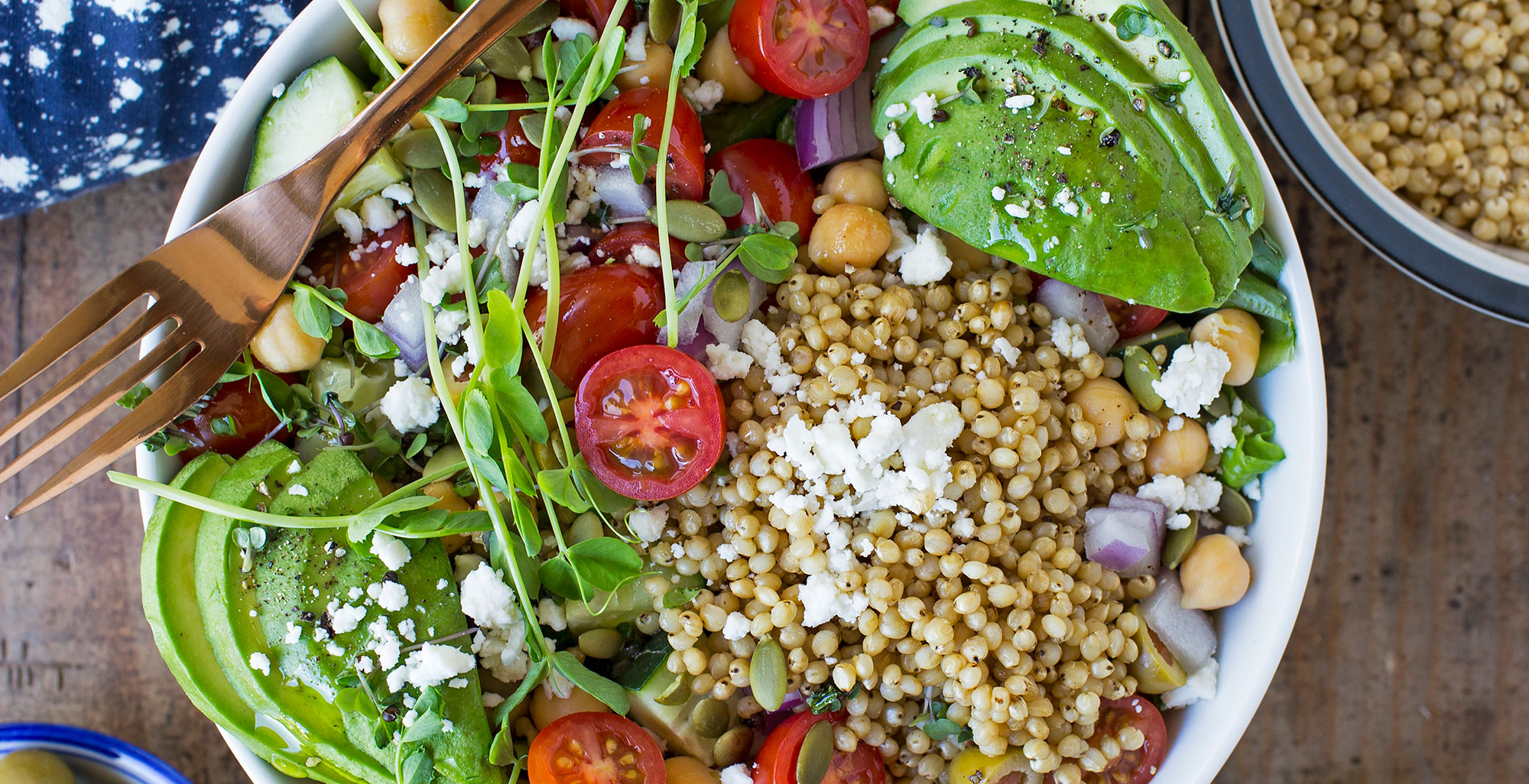 An image of prepared Mediterranean Sorghum Bone Broth Bowl made with sorghum, Pacific Foods® Unsalted Organic Chicken Bone Broth, spinach, chickpeas, cherry tomatoes, cucumber, red onion, feta cheese, avocado and olive oil.