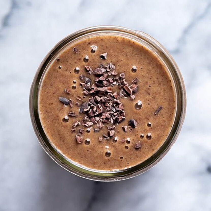 An image of prepared Mocha Maca Smoothie made with banana, dates, Pacific Foods® Organic Oat Original Beverage. coffee, cocoa nibs and maca powder.