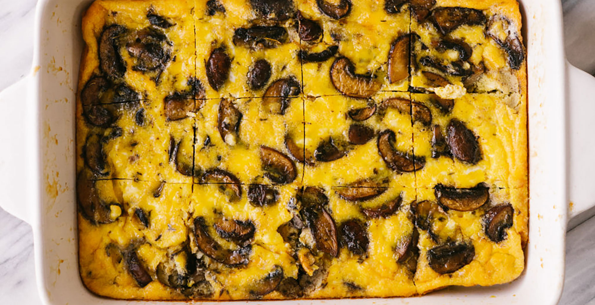 An image of prepared Mushroom and Feta Breakfast Casserole made with mushrooms, eggs, feta and Pacific Foods® Organic Cream Of Mushroom Condensed Soup.