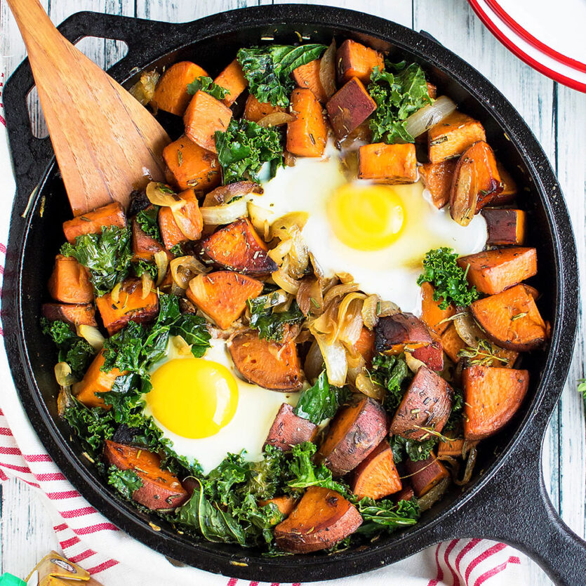 An image of prepared One-Skillet Sweet Potato and Kale Hash made with sweet potato, kale, Pacific Foods® Organic Chicken Bone Broth and eggs.